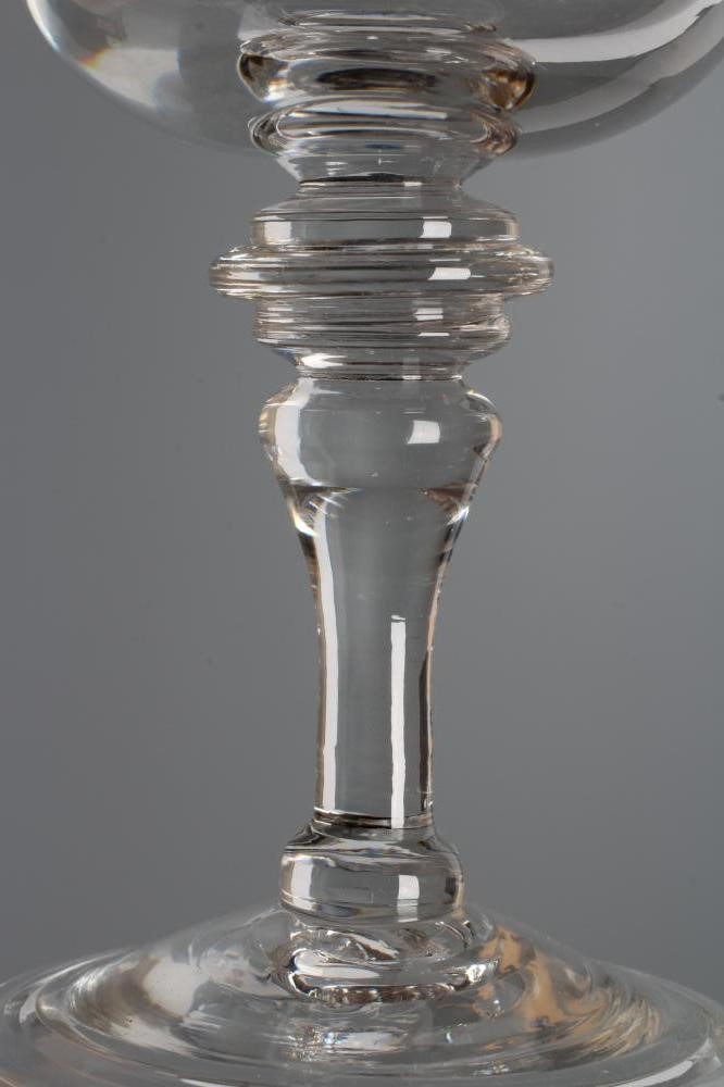 A MEAD GLASS, early 18th century, the plain cup bowl issuing from a triple ringed annular top knop Image