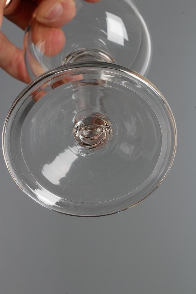 A MEAD GLASS, early 18th century, the plain cup bowl issuing from a triple ringed annular top knop Image