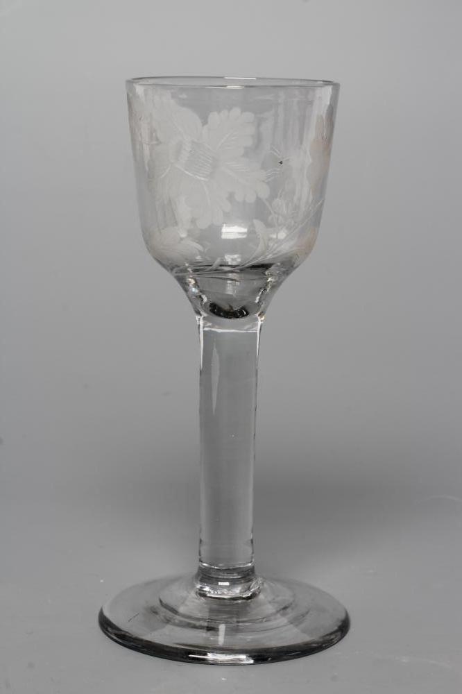A JACOBITE WINE GLASS, mid 18th century, the ogee bowl engraved with oak leaves, a moth and other Image