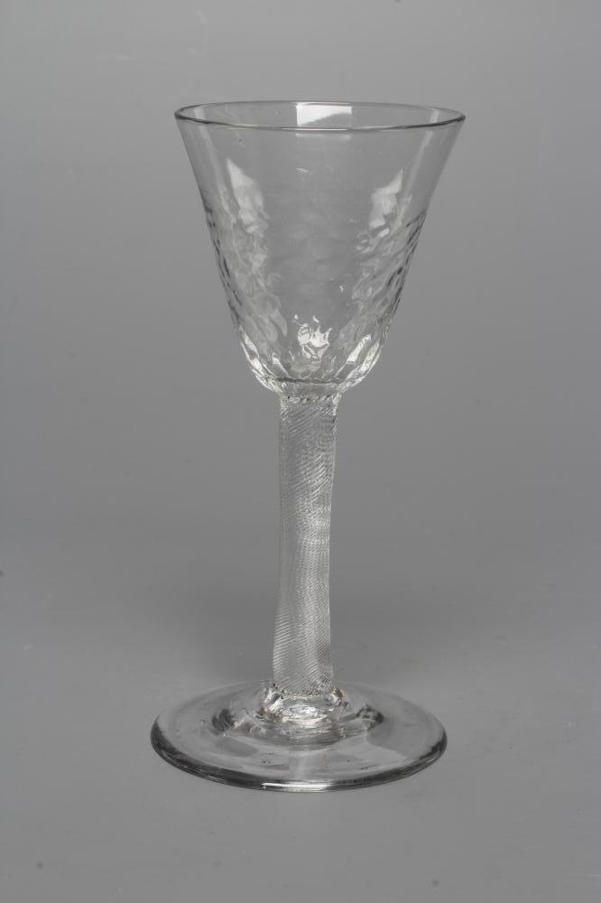 A WINE GLASS, mid 18th century, the honeycomb moulded blown round funnel bowl on finely incised Image