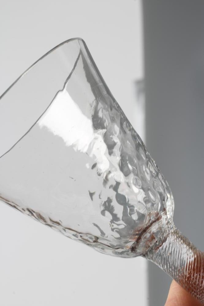 A WINE GLASS, mid 18th century, the honeycomb moulded blown round funnel bowl on finely incised Image