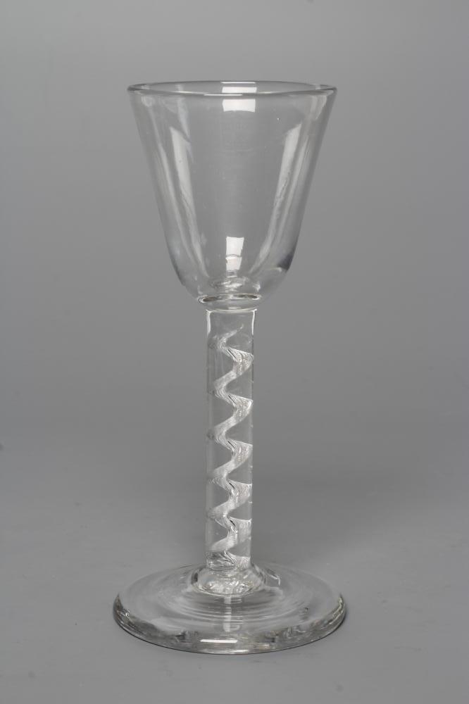 A CORDIAL GLASS, mid 18th century, the plain round funnel bowl on a simple single series air twist Image