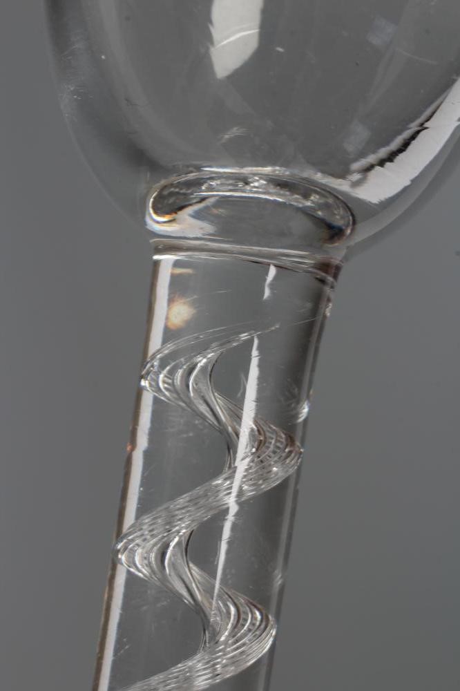 A CORDIAL GLASS, mid 18th century, the plain round funnel bowl on a simple single series air twist Image