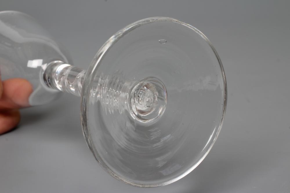 A CORDIAL GLASS, mid 18th century, the plain round funnel bowl on a simple single series air twist Image