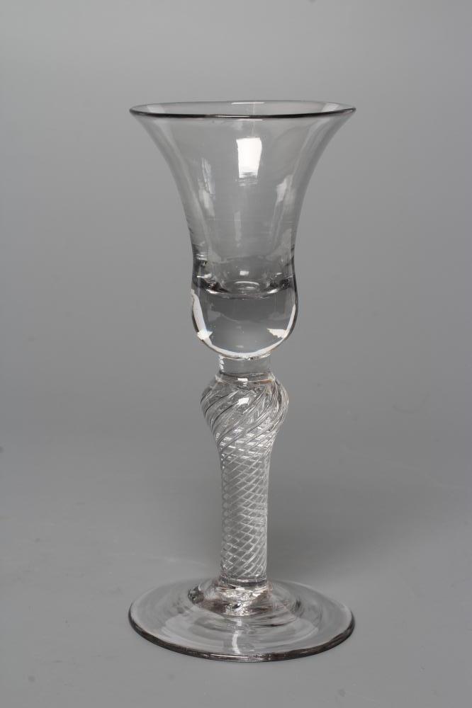 A WINE GLASS, mid 18th century, the bell bowl issuing from an inverted baluster multiple spiral air Image