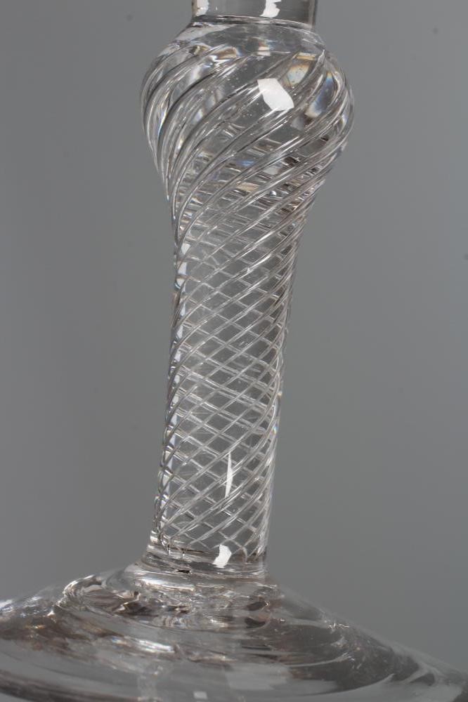 A WINE GLASS, mid 18th century, the bell bowl issuing from an inverted baluster multiple spiral air Image