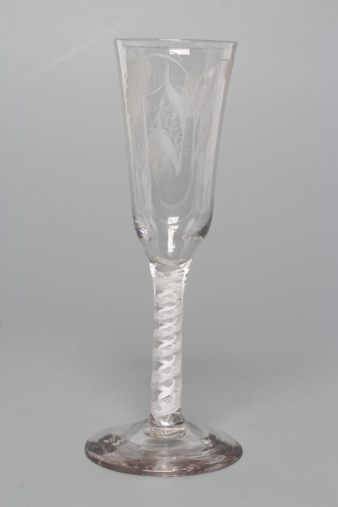 A GLASS ALE FLUTE, mid 18th century, the round funnel bowl engraved with hops and barley on a multi Image