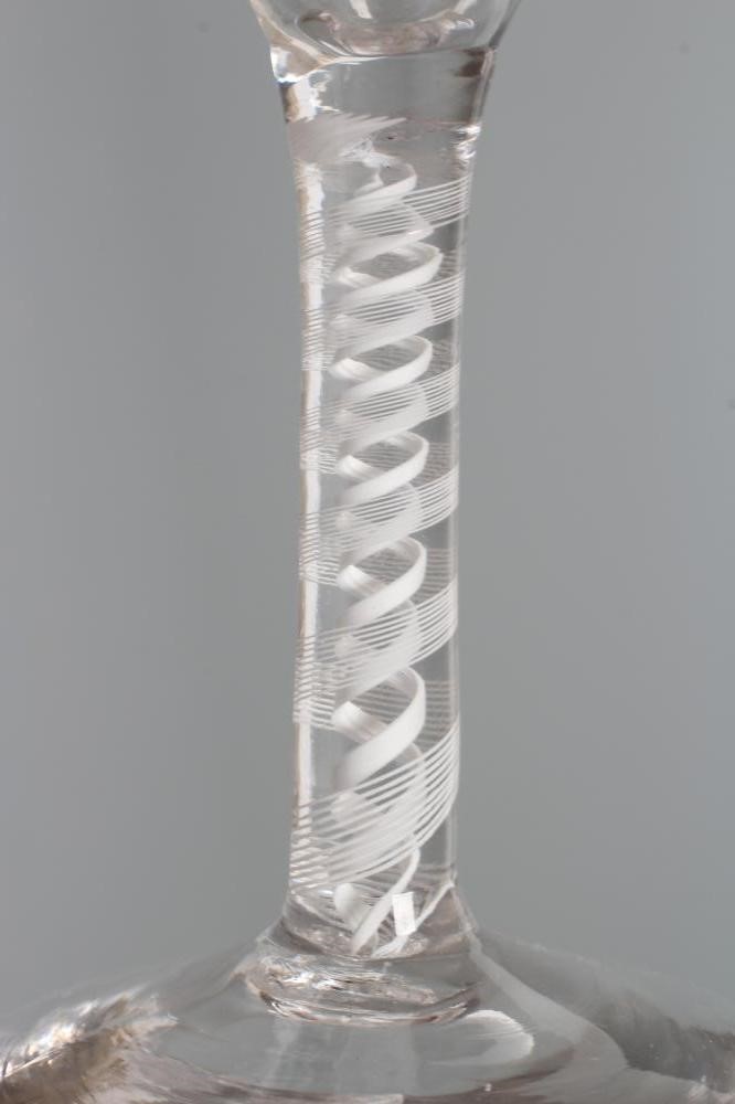 A GLASS ALE FLUTE, mid 18th century, the round funnel bowl engraved with hops and barley on a multi Image