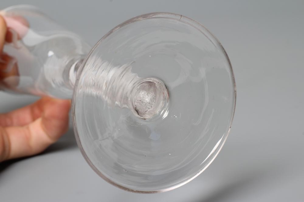 A GLASS ALE FLUTE, mid 18th century, the round funnel bowl engraved with hops and barley on a multi Image