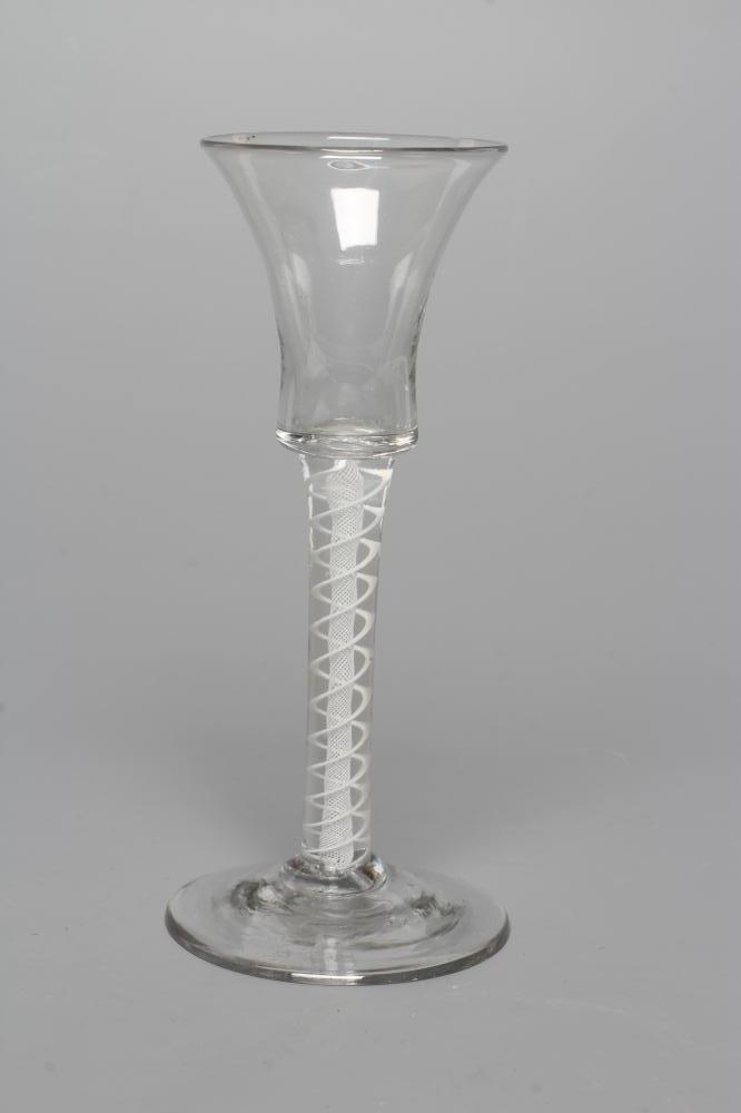 A CORDIAL GLASS, mid 18th century, the plain bell bowl on a bold opaque twist stem with central Image