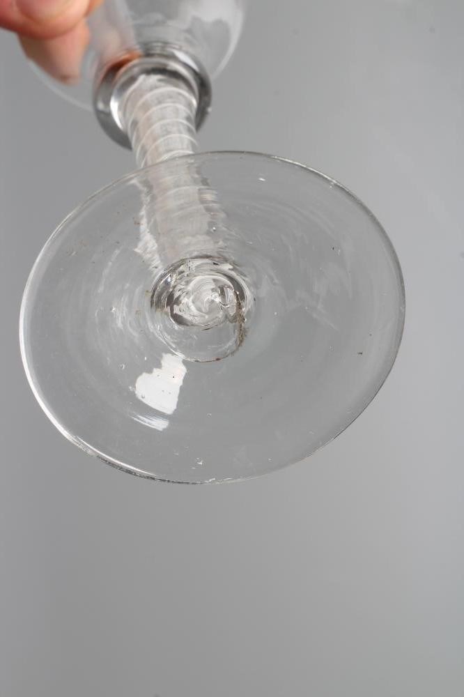 A CORDIAL GLASS, mid 18th century, the plain bell bowl on a bold opaque twist stem with central Image
