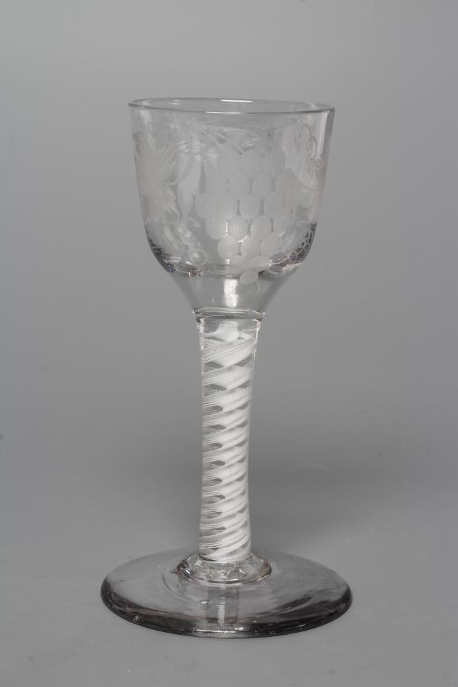 A WINE GLASS, mid 18th century, the ogee bowl engraved with fruiting vine and a bird in flight on an Image