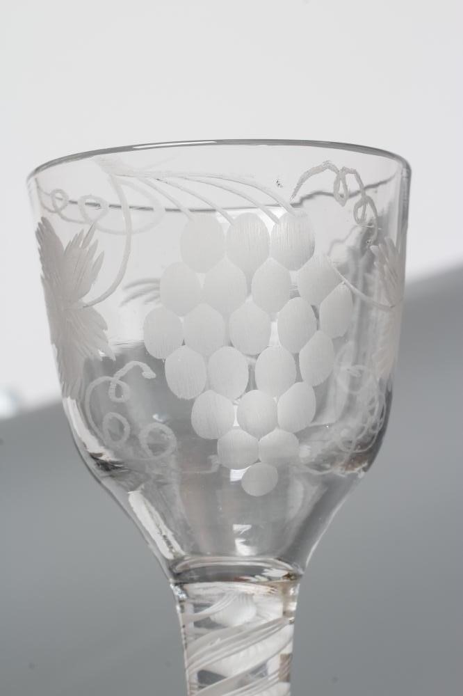 A WINE GLASS, mid 18th century, the ogee bowl engraved with fruiting vine and a bird in flight on an Image