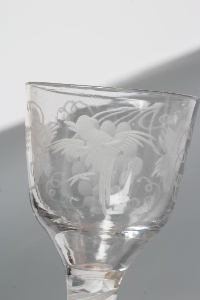 A WINE GLASS, mid 18th century, the ogee bowl engraved with fruiting vine and a bird in flight on an Image