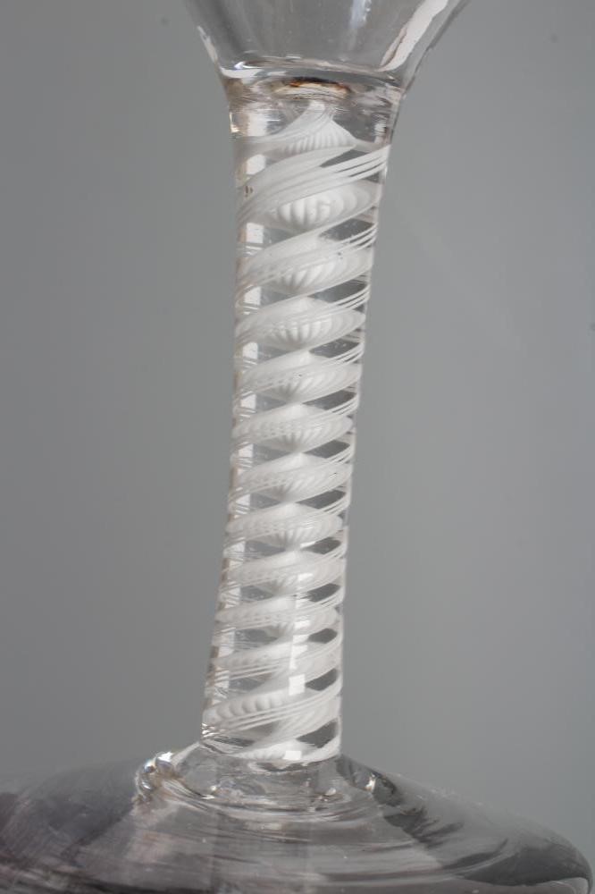 A WINE GLASS, mid 18th century, the ogee bowl engraved with fruiting vine and a bird in flight on an Image