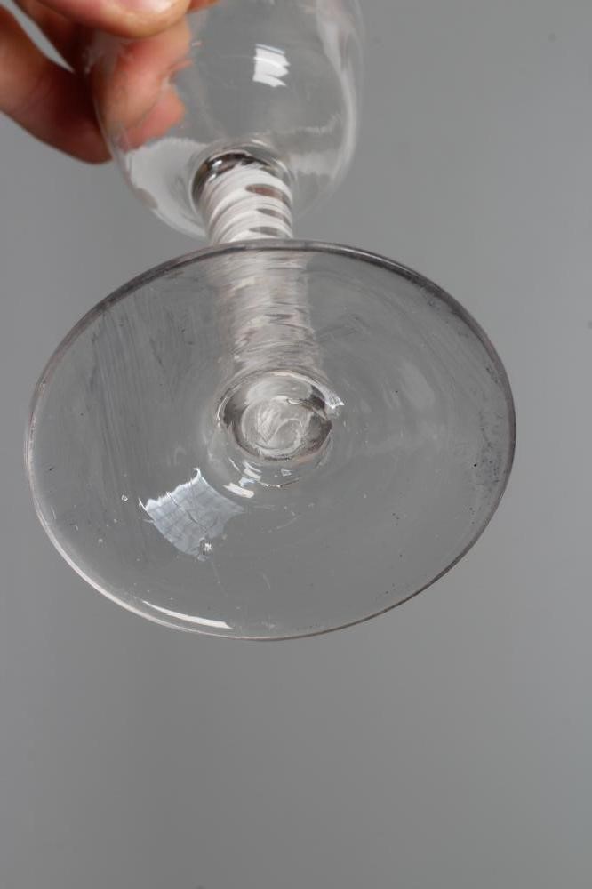 A WINE GLASS, mid 18th century, the ogee bowl engraved with fruiting vine and a bird in flight on an Image