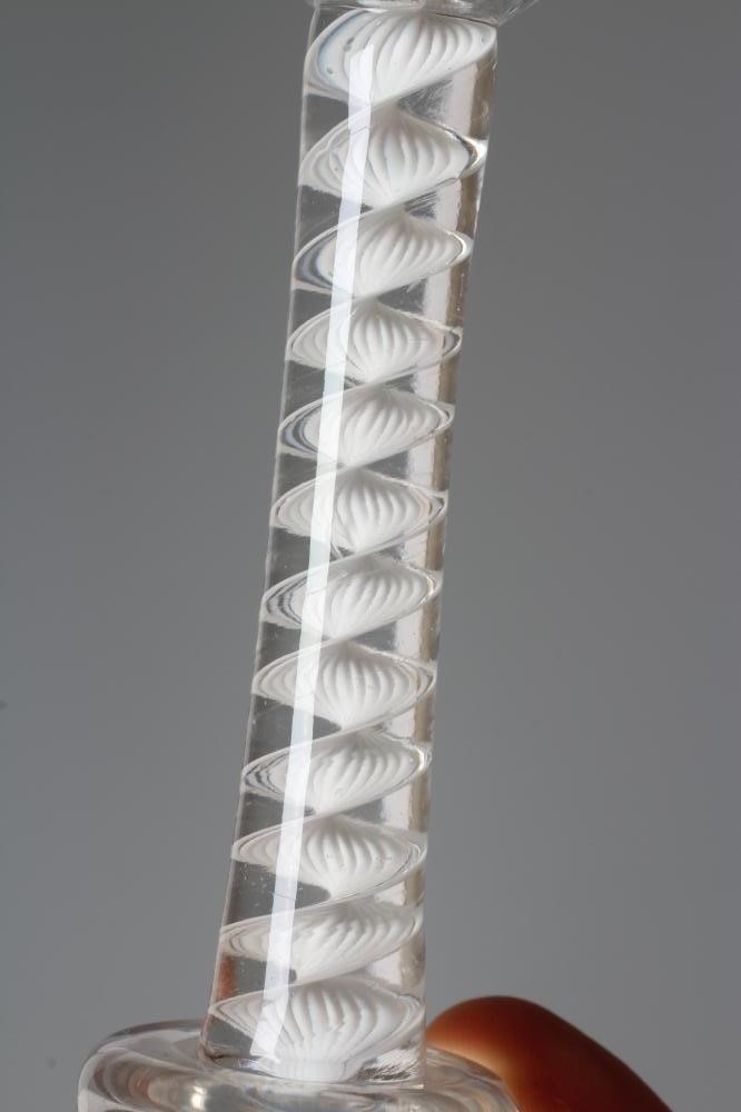 A CORDIAL GLASS, mid 18th century, the plain waisted bucket bowl on a single series opaque twist Image