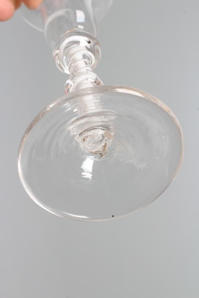 A WINE GLASS, mid 18th century, the plain bell bowl on a double series opaque twist stem with three Image