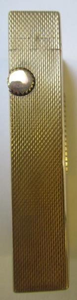 A DUNHILL 9CT GOLD ROLLAGAS CIGARETTE LIGHTER of plain oblong form with engine turning, 2 1/2" high, Image