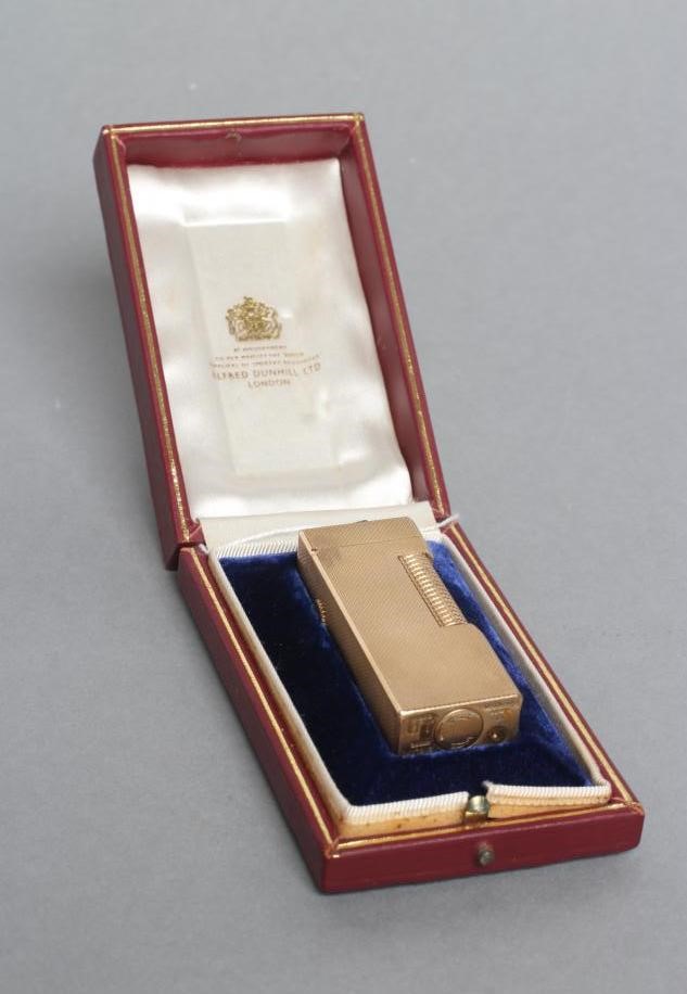 A DUNHILL 9CT GOLD ROLLAGAS CIGARETTE LIGHTER of plain oblong form with engine turning, 2 1/2" high, Image