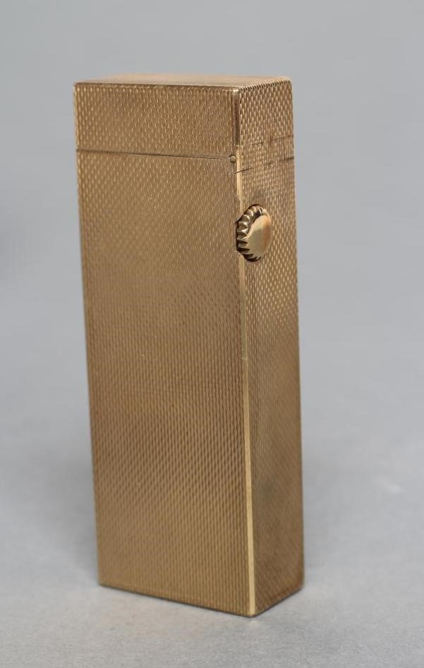 A DUNHILL 9CT GOLD ROLLAGAS CIGARETTE LIGHTER of plain oblong form with engine turning, 2 1/2" high, Image