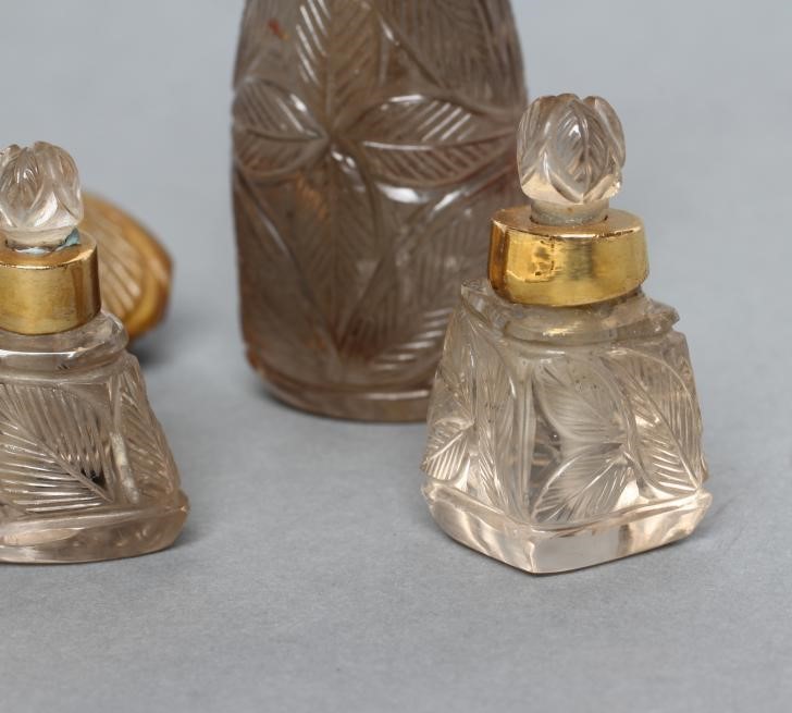 A BANDED AGATE PERFUME BOTTLE AND STOPPER carved and polished in low relief with palm fronds Image
