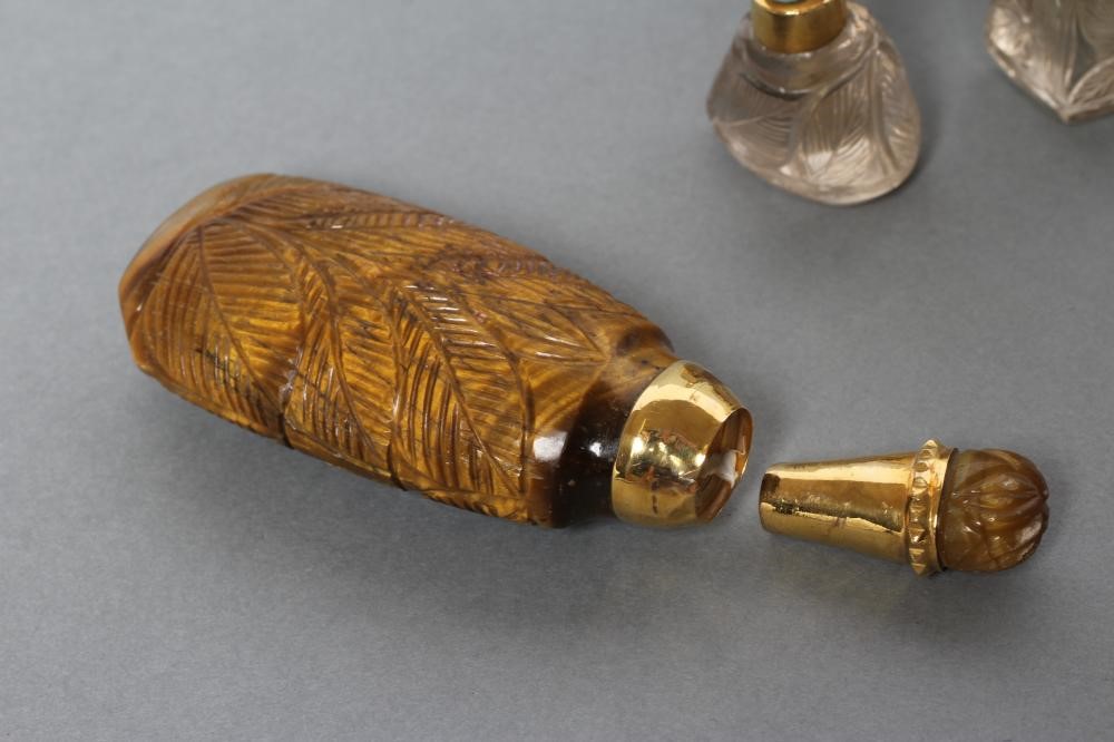 A BANDED AGATE PERFUME BOTTLE AND STOPPER carved and polished in low relief with palm fronds Image
