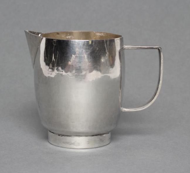 A SMALL SILVER JUG, maker Nancy Goodman, London 1975, of planished slightly bombe cylindrical form Image