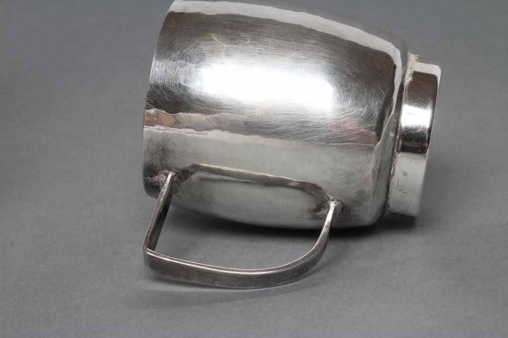 A SMALL SILVER JUG, maker Nancy Goodman, London 1975, of planished slightly bombe cylindrical form Image
