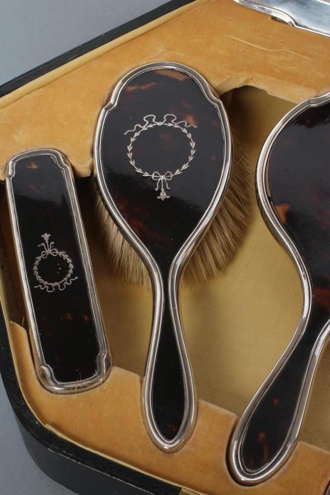 A SILVER AND TORTOISESHELL PIQUE WORK DRESSING TABLE SET Image