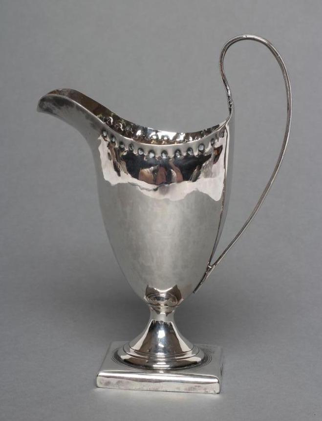 A LATE GEORGE III SILVER HELMET JUG Image