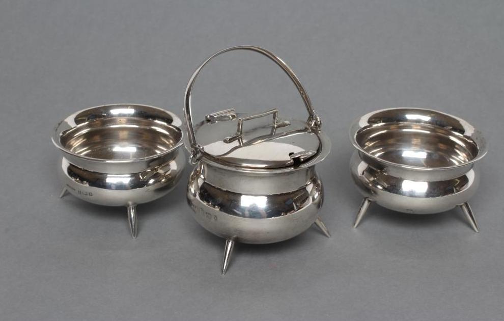 A LATE VICTORIAN NOVELTY THREE PIECE SILVER CAULDRON CRUET Image