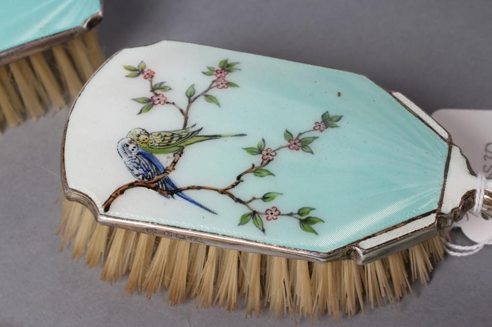 A THREE PIECE SILVER AND ENAMEL DRESSING TABLE SET Image