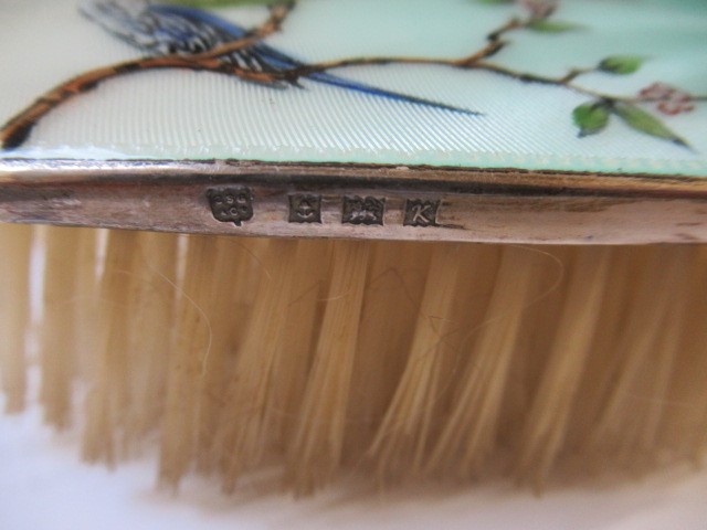 A THREE PIECE SILVER AND ENAMEL DRESSING TABLE SET Image