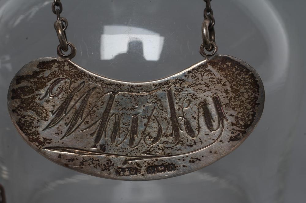 A PAIR OF MINIATURE SILVER MOUNTED GLASS WHISKY DECANTERS and covers Image