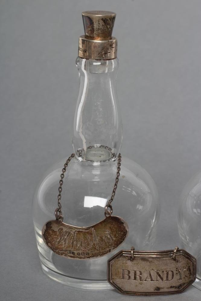 A PAIR OF MINIATURE SILVER MOUNTED GLASS WHISKY DECANTERS and covers Image