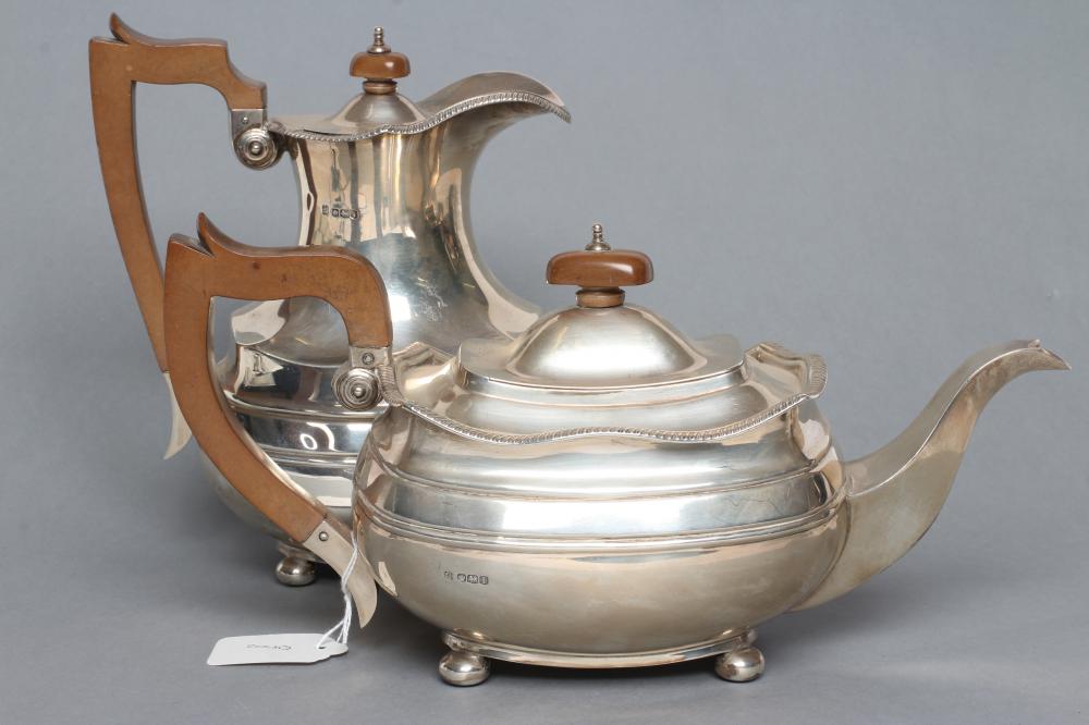 A SILVER TEAPOT AND MATCHING COFFEE POT Image