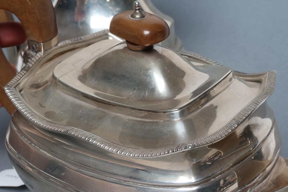 A SILVER TEAPOT AND MATCHING COFFEE POT Image