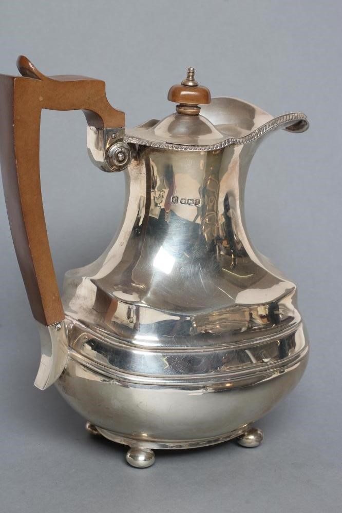 A SILVER TEAPOT AND MATCHING COFFEE POT Image