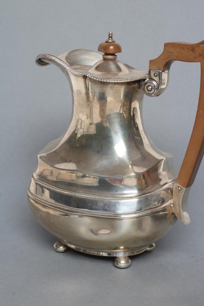 A SILVER TEAPOT AND MATCHING COFFEE POT Image