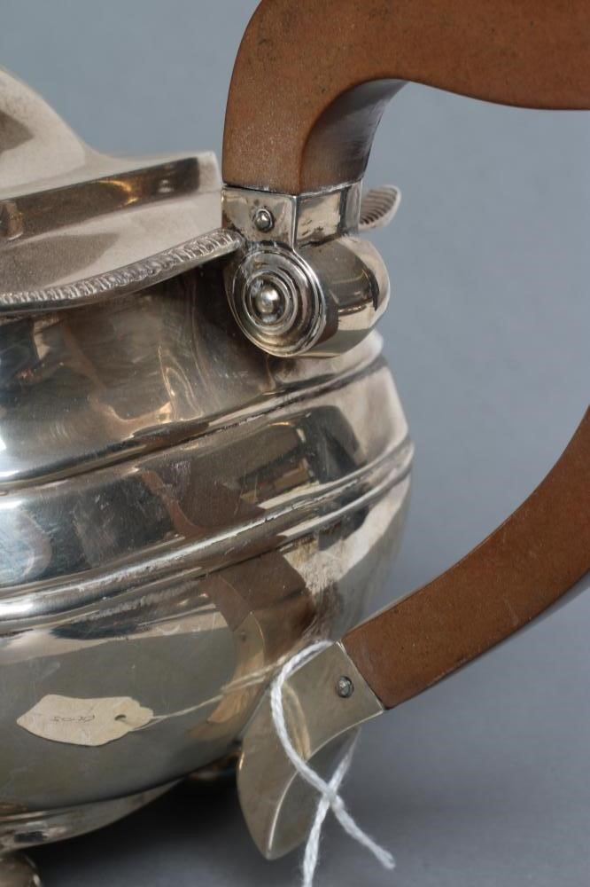 A SILVER TEAPOT AND MATCHING COFFEE POT Image