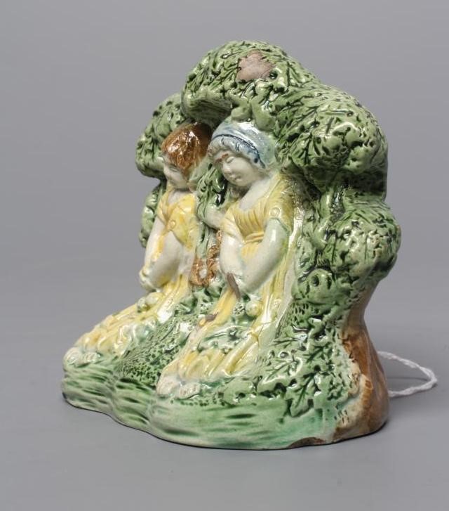 A STAFFORDSHIRE PRATTWARE SLIP CAST GROUP, early 19th century, modelled as the Babes in the Wood, Image