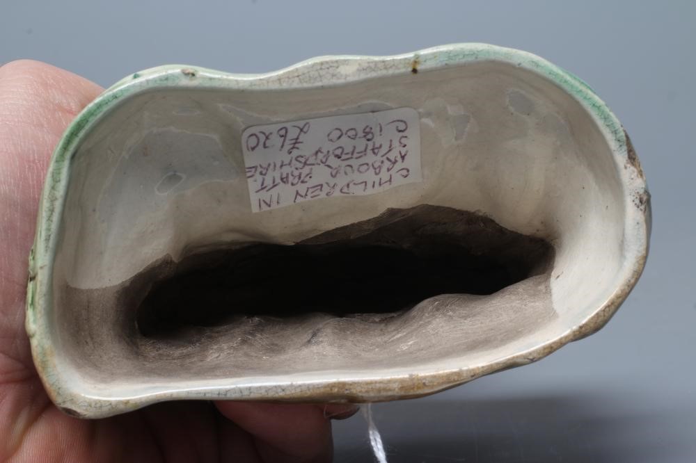 A STAFFORDSHIRE PRATTWARE SLIP CAST GROUP, early 19th century, modelled as the Babes in the Wood, Image