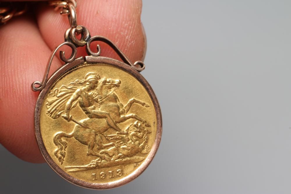 A GEORGE V HALF SOVEREIGN, 1912, in a 9ct gold loose mount and pendant from a graduated curb link Image