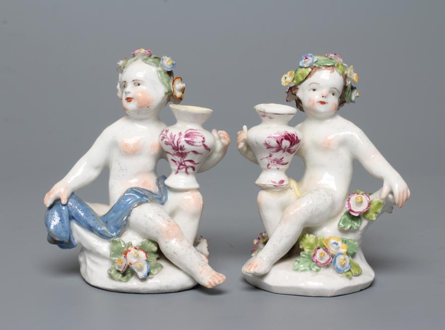 A PAIR OF BOW PORCELAIN PUTTI Image