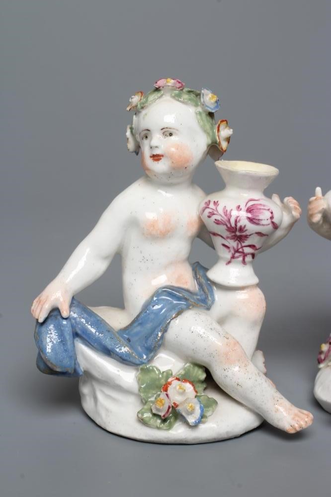 A PAIR OF BOW PORCELAIN PUTTI Image