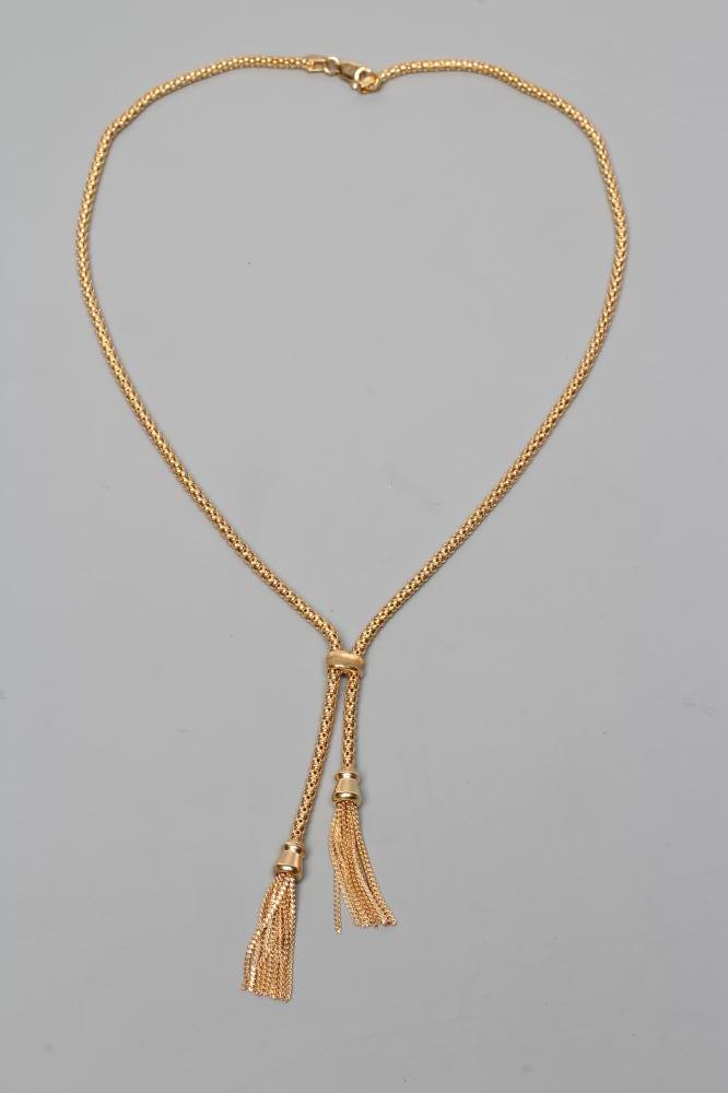 A TASSEL NECKLACE, the hollow bead type links terminating in two tassels, the lobster clasp stamped Image