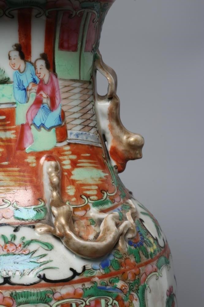 A PAIR OF CANTONESE PORCELAIN FAMILLE ROSE VASES of cylindrical form with waisted necks Image
