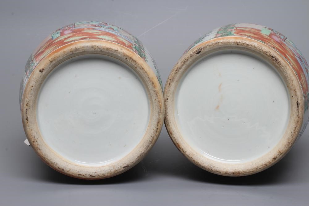 A PAIR OF CANTONESE PORCELAIN FAMILLE ROSE VASES of cylindrical form with waisted necks Image