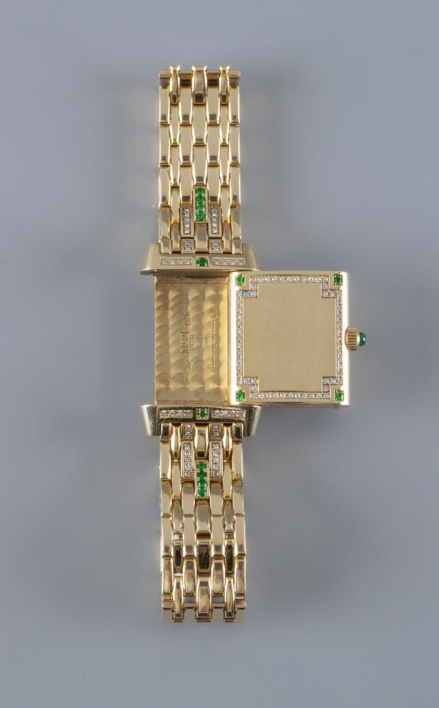 A LADY'S JAEGER-LECOULTRE EMERALD AND DIAMOND REVERSO WRISTWATCH/BRACELET Image